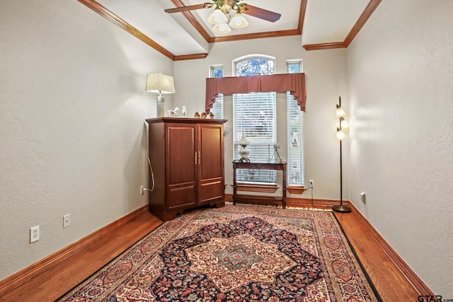 foyer with hardwood / wood-style floors, crown molding, and ceiling fan