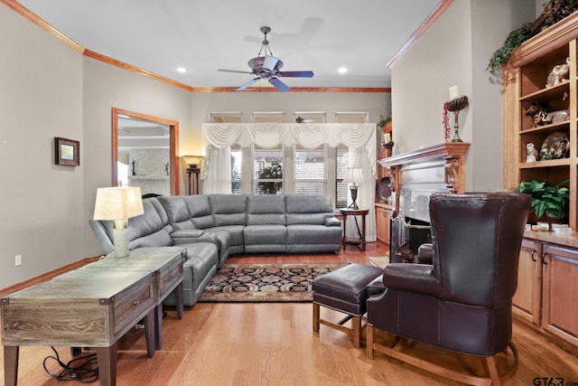 living room featuring crown molding, ceiling fan, and light hardwood / wood-style flooring