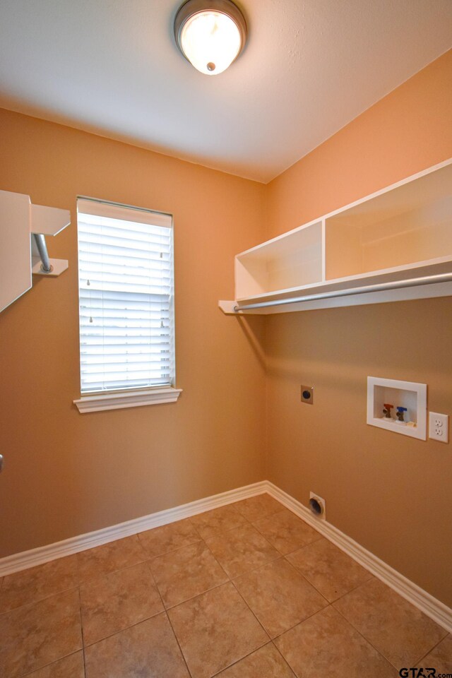 washroom with hookup for an electric dryer, tile patterned flooring, and hookup for a washing machine