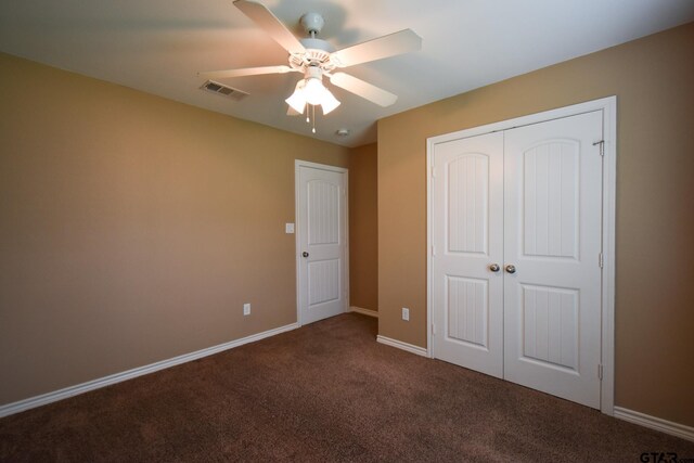 unfurnished bedroom featuring a closet, carpet flooring, and ceiling fan