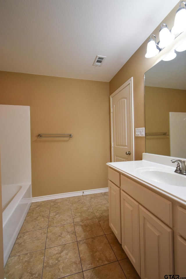 bathroom with vanity, a bath, and tile patterned flooring