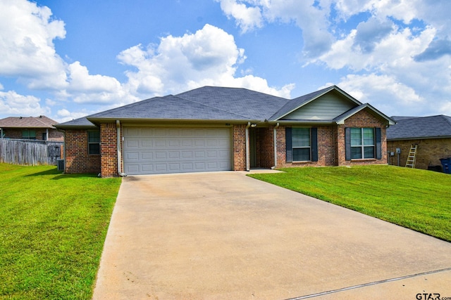 ranch-style home featuring a garage and a front lawn