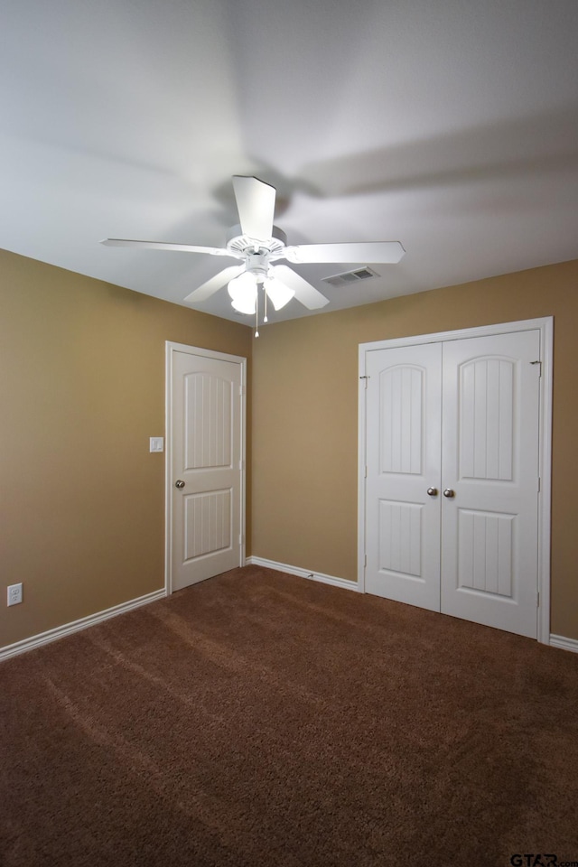 unfurnished bedroom with ceiling fan and carpet flooring