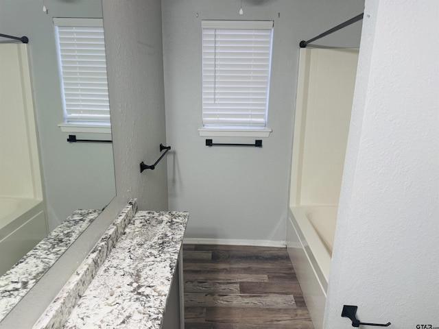 bathroom featuring vanity, hardwood / wood-style flooring, and shower / bathing tub combination