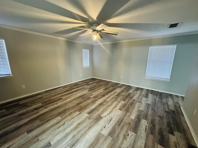 spare room with hardwood / wood-style flooring, crown molding, and ceiling fan