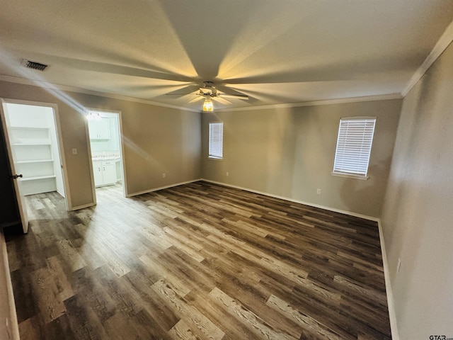 unfurnished room with ceiling fan, ornamental molding, and dark hardwood / wood-style flooring