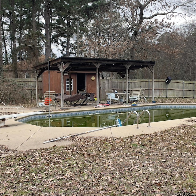 view of swimming pool with an outdoor structure and a patio