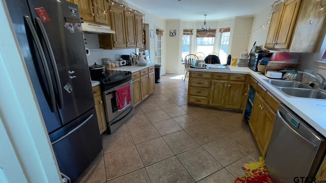 kitchen featuring light tile patterned flooring, sink, decorative light fixtures, appliances with stainless steel finishes, and kitchen peninsula