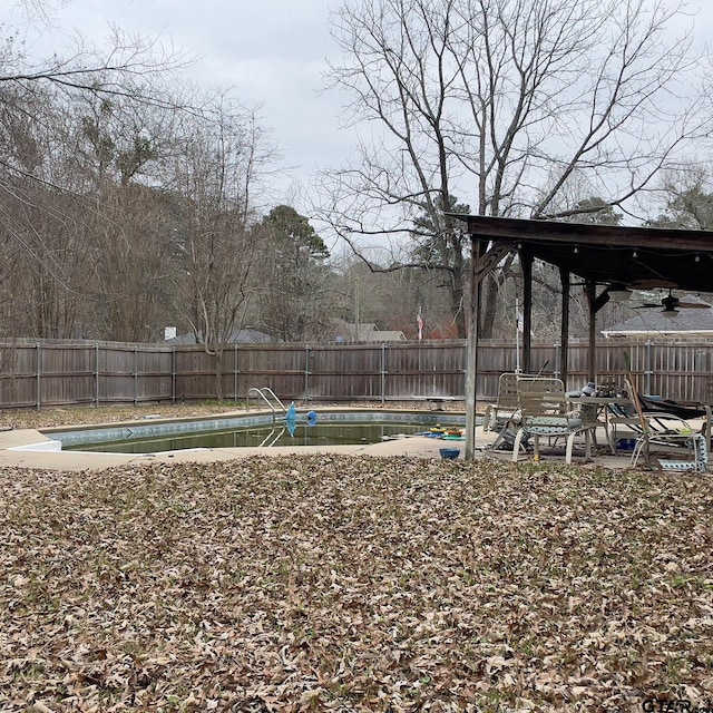 view of yard with a fenced in pool and a patio