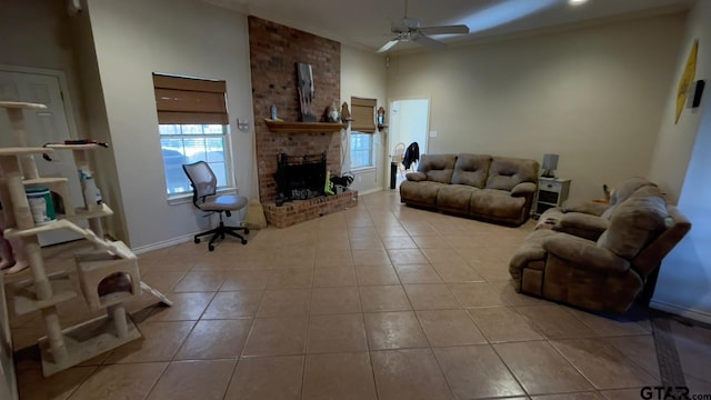 living room with ceiling fan, a brick fireplace, and light tile patterned floors