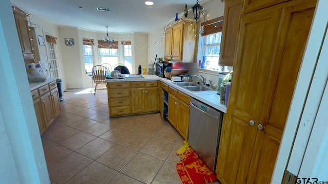 kitchen featuring sink, hanging light fixtures, light tile patterned floors, kitchen peninsula, and dishwasher