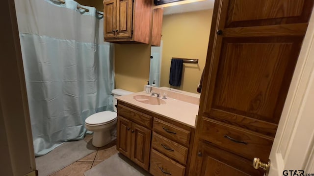 bathroom featuring tile patterned floors, toilet, and vanity