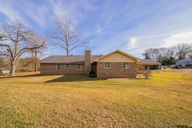 rear view of house featuring a lawn