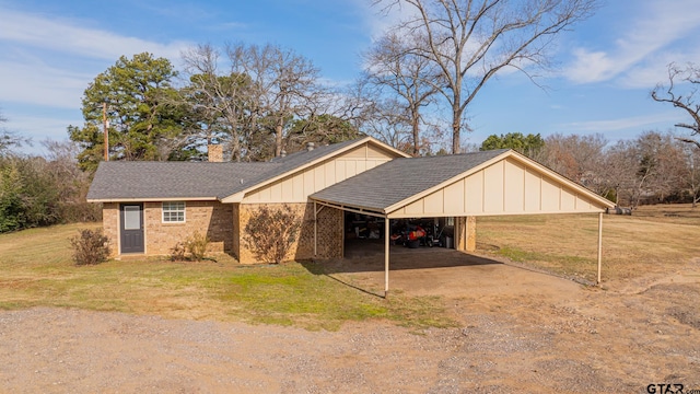 exterior space featuring a yard and a carport