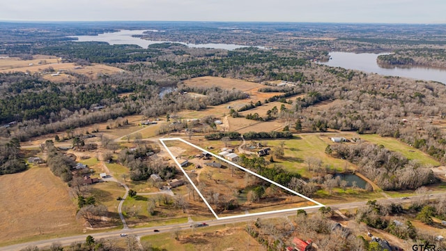 birds eye view of property featuring a water view and a rural view