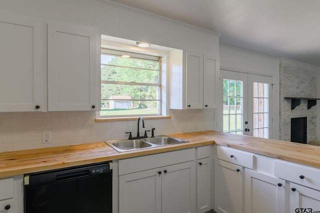 3803 Peavine Rd, Kilgore, TX 75662 - kitchen with wood counters, black dishwasher, a sink, decorative backsplash, and ornamental molding