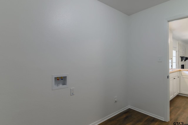 3803 Peavine Rd, Kilgore, TX 75662 - laundry area with cabinet space, dark wood finished floors, hookup for a washing machine, and baseboards