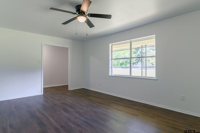 3803 Peavine Rd, Kilgore, TX 75662 - empty room featuring dark wood-type flooring, baseboards, and a ceiling fan