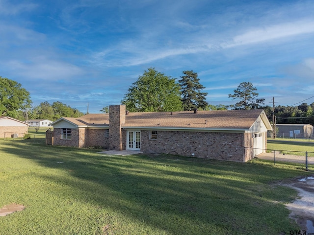 3803 Peavine Rd, Kilgore, TX 75662 - rear view of property with french doors, a garage, brick siding, and a chimney