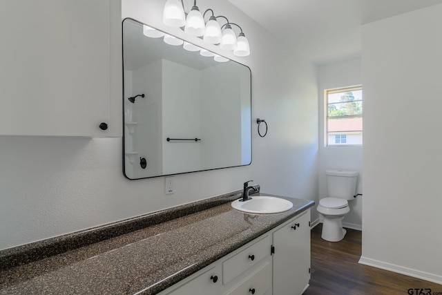 3803 Peavine Rd, Kilgore, TX 75662 - bathroom featuring wood finished floors, baseboards, toilet, and vanity