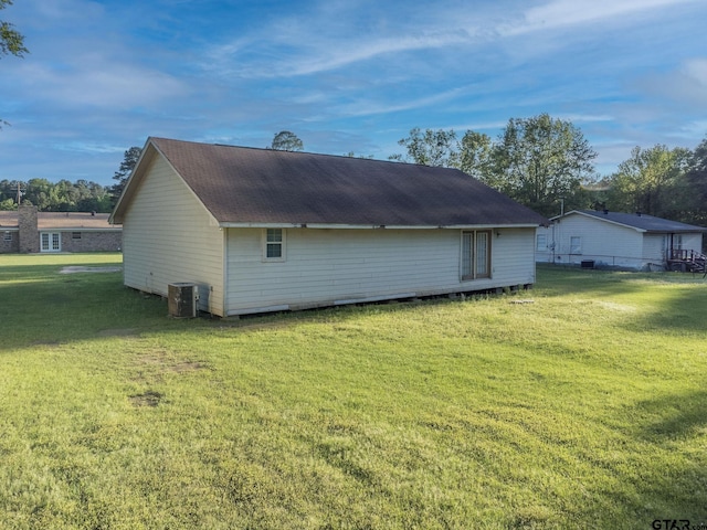 3803 Peavine Rd, Kilgore, TX 75662 - view of home's exterior featuring a yard, cooling unit, and roof with shingles
