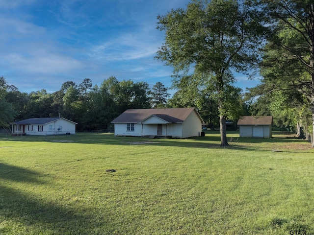 3803 Peavine Rd, Kilgore, TX 75662 - view of front facade with a front lawn, an outbuilding, and a storage unit