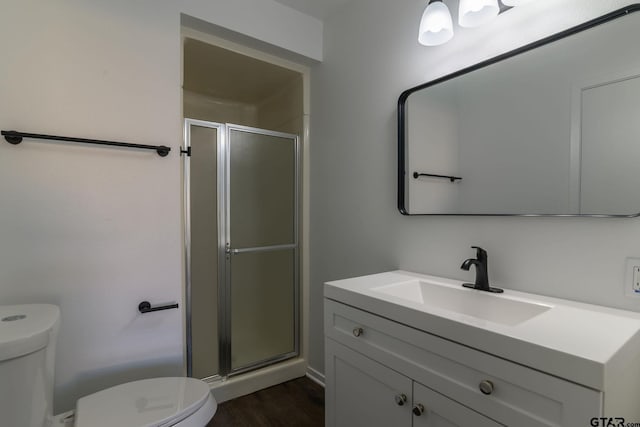3803 Peavine Rd, Kilgore, TX 75662 - bathroom with toilet, a stall shower, wood finished floors, and vanity