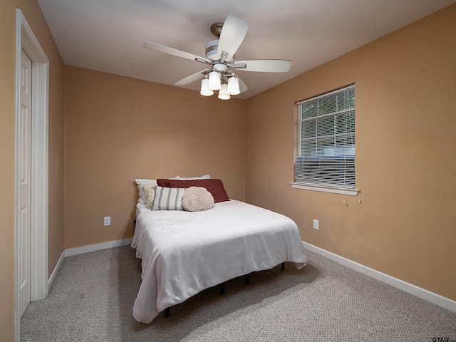 bedroom featuring ceiling fan and carpet