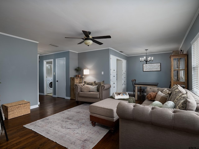 living room with washer / clothes dryer, crown molding, ceiling fan with notable chandelier, and dark hardwood / wood-style floors