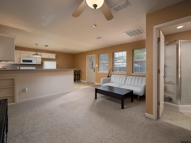 living room featuring ceiling fan and light carpet