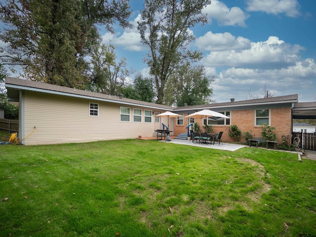 back of property featuring a yard and a patio area