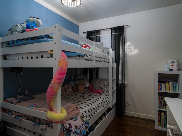 bedroom with dark hardwood / wood-style floors