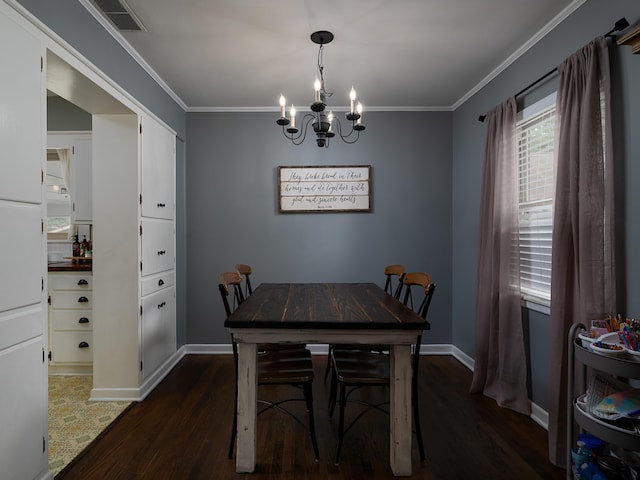 dining room featuring ornamental molding, dark hardwood / wood-style floors, and a notable chandelier