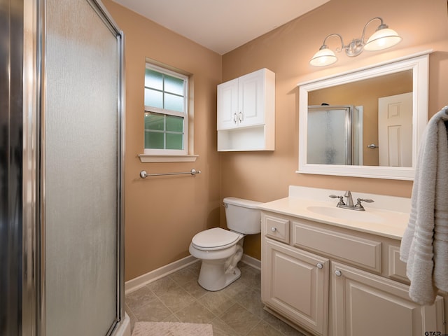 bathroom featuring tile patterned floors, vanity, toilet, and an enclosed shower