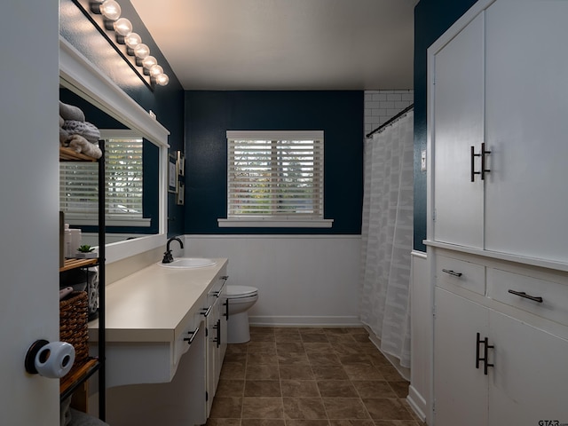 bathroom featuring walk in shower, vanity, and toilet