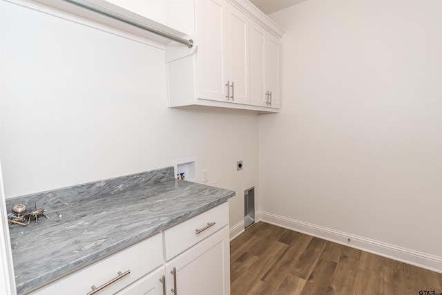 laundry room featuring cabinets, dark hardwood / wood-style floors, hookup for a washing machine, and electric dryer hookup