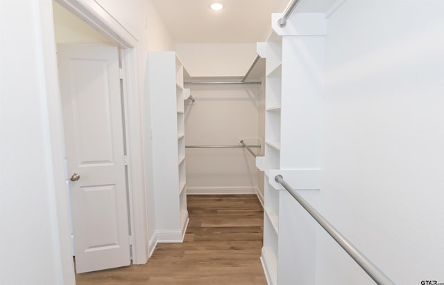 walk in closet featuring light hardwood / wood-style floors