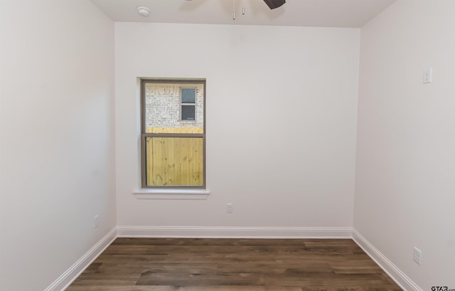 spare room with dark wood-type flooring and ceiling fan