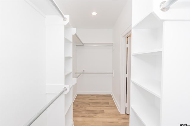 walk in closet with light wood-type flooring