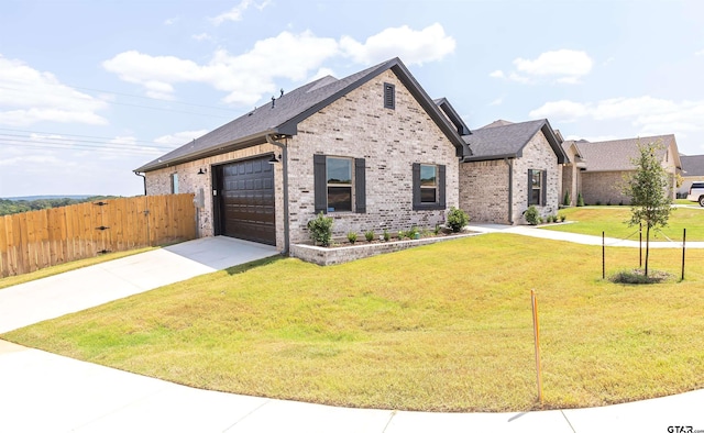 view of front facade with a garage and a front yard