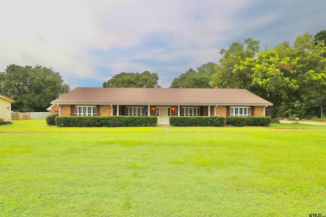 ranch-style home featuring a front yard