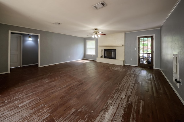 17550 Kristopher Cir, Whitehouse, TX 75791 - unfurnished living room featuring ceiling fan, plenty of natural light, dark wood-style flooring, and a brick fireplace