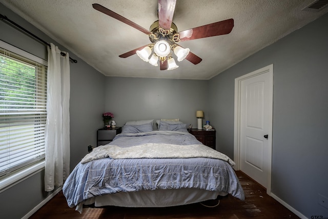 17550 Kristopher Cir, Whitehouse, TX 75791 - bedroom featuring wood finished floors, ceiling fan, and a textured ceiling