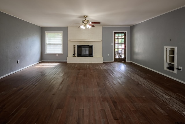 17550 Kristopher Cir, Whitehouse, TX 75791 - unfurnished living room with ceiling fan, dark wood-type flooring, and a brick fireplace