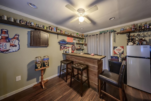 17550 Kristopher Cir, Whitehouse, TX 75791 - indoor dry bar featuring freestanding refrigerator, a ceiling fan, crown molding, dark wood-style floors, and recessed lighting