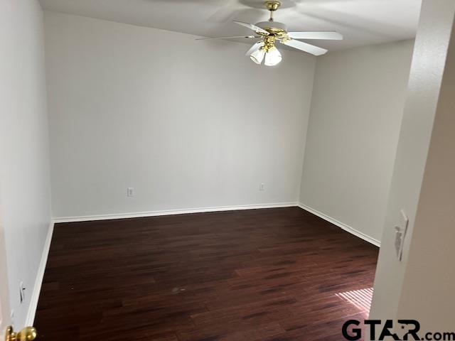 1712 Onyx Cv, Whitehouse, TX 75791 - unfurnished room featuring dark wood-style flooring and a ceiling fan