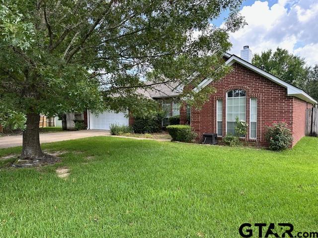 1712 Onyx Cv, Whitehouse, TX 75791 - obstructed view of property featuring brick siding, a chimney, a front yard, concrete driveway, and an attached garage