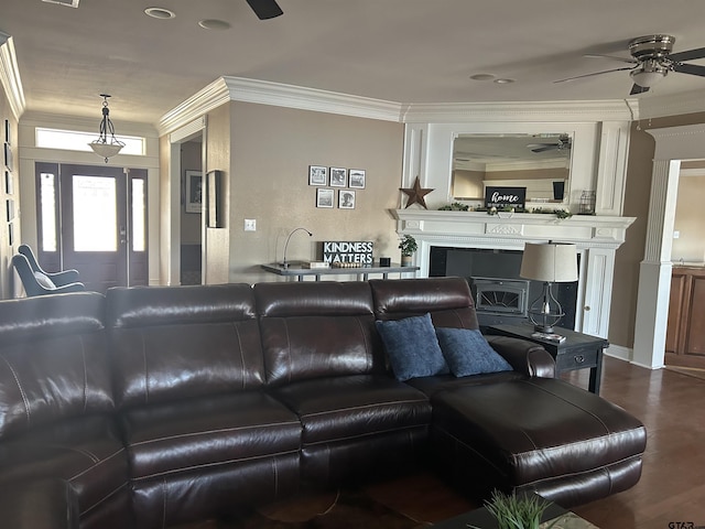 living room featuring ceiling fan, ornamental molding, and wood-type flooring