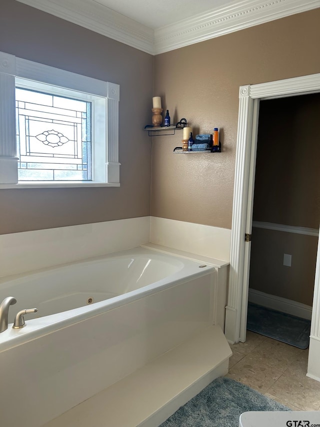 bathroom with tile patterned floors, ornamental molding, and a washtub