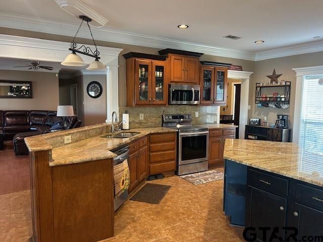 kitchen featuring sink, crown molding, appliances with stainless steel finishes, decorative light fixtures, and kitchen peninsula